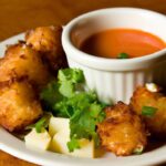 Crispy Cassava Fritters with a Zesty Chili Dip Delight